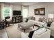 Bright living room features stylish decor, comfortable seating, neutral color palette, and large windows at 2193 Aibonito Cir, Clermont, FL 34711