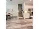Open-concept living area with view of modern kitchen, dining space, and staircase at 5232 Luisa Ct, St Cloud, FL 34771