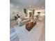Spacious living area featuring an open layout, modern furnishings, and a view of the kitchen at 5232 Luisa Ct, St Cloud, FL 34771