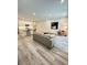 Bright, open-concept living room with modern finishes, including a sleek kitchen and stylish decor at 5232 Luisa Ct, St Cloud, FL 34771