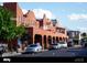 View of multi-story historic building and vehicles lining a quiet street at 5232 Luisa Ct, St Cloud, FL 34771