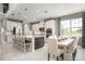 Modern kitchen features stainless steel appliances, island with bar seating, and white cabinetry at 136 Venetian Palms Blvd, New Smyrna Beach, FL 32168