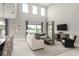 Bright living area featuring high ceilings and a view into the eat in kitchen at 136 Venetian Palms Blvd, New Smyrna Beach, FL 32168