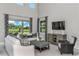 Cozy living room with large windows offering scenic backyard views at 136 Venetian Palms Blvd, New Smyrna Beach, FL 32168