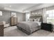 Spacious main bedroom with tray ceiling, neutral color scheme, and stylish furnishings at 136 Venetian Palms Blvd, New Smyrna Beach, FL 32168