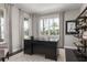 Bright office with sleek black desk, large windows, elegant curtains, and stylish shelving at 136 Venetian Palms Blvd, New Smyrna Beach, FL 32168