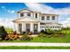 Beautiful two-story home with a manicured lawn and welcoming front porch at 3210 Tiger Palm Way, New Smyrna Beach, FL 32168