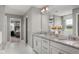 Bright bathroom features double sinks, a granite countertop, large mirror, and access to an additional living space at 3250 Tiger Palm Way, New Smyrna Beach, FL 32168