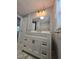 Bathroom with white vanity, marble floors, and updated mirror and lighting at 2827 Se 2Nd St, Ocala, FL 34471