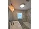 Elegant bathroom with marble tile, modern fixtures, and a soaking tub at 2827 Se 2Nd St, Ocala, FL 34471