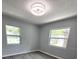Bright bedroom featuring two windows, neutral paint, and modern ceiling light at 2827 Se 2Nd St, Ocala, FL 34471