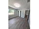 Bedroom featuring wood-look floors, closet, neutral paint, and ample natural light at 2827 Se 2Nd St, Ocala, FL 34471