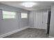 Spacious bedroom with gray walls, hardwood flooring, and ample natural light from windows at 2827 Se 2Nd St, Ocala, FL 34471