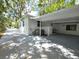 Side view of the home showing the large covered carport and AC unit at 2827 Se 2Nd St, Ocala, FL 34471