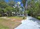 Charming single-story home with mature trees, landscaped yard, and long driveway at 2827 Se 2Nd St, Ocala, FL 34471