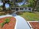 Charming single-story home featuring a landscaped front yard and inviting walkway at 2827 Se 2Nd St, Ocala, FL 34471