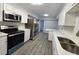 Modern kitchen featuring stainless steel appliances, white cabinets and tiled backsplash at 2827 Se 2Nd St, Ocala, FL 34471