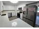 Modern kitchen with stainless steel appliances, white cabinets, and quartz countertops at 2827 Se 2Nd St, Ocala, FL 34471