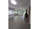 Open living area with wood floors, brick fireplace, and abundant natural light at 2827 Se 2Nd St, Ocala, FL 34471