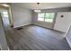 Spacious living area features hardwood floors, natural lighting, and a modern light fixture at 2827 Se 2Nd St, Ocala, FL 34471