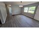 Open room with large window and updated gray wood flooring at 2827 Se 2Nd St, Ocala, FL 34471