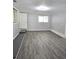 Living room featuring gray walls, hardwood flooring, natural light, and access to other rooms at 2827 Se 2Nd St, Ocala, FL 34471