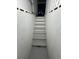 Concrete basement stairwell with newly painted steps and walls at 2827 Se 2Nd St, Ocala, FL 34471