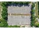 Aerial view of a large parking lot surrounded by mature green trees on a sunny day at 8596 Sw 108Th Place Rd, Ocala, FL 34481