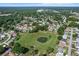 Aerial view of the community showcasing green space with pond and single Gathering homes in a quiet neighborhood at 8596 Sw 108Th Place Rd, Ocala, FL 34481