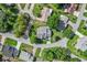 Aerial shot of a home nestled in a tranquil neighborhood with mature trees and well-manicured lawns at 8596 Sw 108Th Place Rd, Ocala, FL 34481