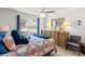 Bright bedroom with colorful comforter, dresser, side chair and large window at 8596 Sw 108Th Place Rd, Ocala, FL 34481