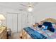 Comfortable bedroom featuring a ceiling fan, large closet and a charming vanity area at 8596 Sw 108Th Place Rd, Ocala, FL 34481