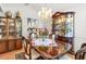 Elegant dining room with a chandelier and display cabinets, perfect for showcasing fine dining and creating a sophisticated atmosphere at 8596 Sw 108Th Place Rd, Ocala, FL 34481