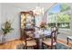 Elegant dining room with a large window, chandelier, and china cabinet showcasing fine dining and a bright, inviting atmosphere at 8596 Sw 108Th Place Rd, Ocala, FL 34481