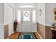 Foyer featuring decorative door with glass insert, hardwood floors, and neutral walls at 8596 Sw 108Th Place Rd, Ocala, FL 34481