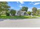 Inviting single-story home featuring lush landscaping, and a well-maintained lawn at 8596 Sw 108Th Place Rd, Ocala, FL 34481