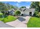 Beautiful home showcasing a well-maintained lawn, lush landscaping, and an attached two-car garage at 8596 Sw 108Th Place Rd, Ocala, FL 34481