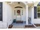 Inviting front porch with decorative wreath and neutral welcome mat at 8596 Sw 108Th Place Rd, Ocala, FL 34481