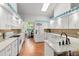 Bright kitchen featuring white cabinets, a mosaic backsplash, and stainless steel appliances, creating a clean and modern cooking space at 8596 Sw 108Th Place Rd, Ocala, FL 34481