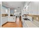 Bright kitchen featuring white cabinets, hardwood floors, and stainless steel appliances at 8596 Sw 108Th Place Rd, Ocala, FL 34481