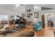 Open concept living room featuring a piano, hardwood floors, and neutral color scheme at 8596 Sw 108Th Place Rd, Ocala, FL 34481
