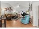 Cozy living room featuring beautiful hardwood floors, piano, and comfortable seating at 8596 Sw 108Th Place Rd, Ocala, FL 34481