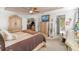 Cozy main bedroom features a ceiling fan, and entryways to a living room and the ensuite bath at 8596 Sw 108Th Place Rd, Ocala, FL 34481