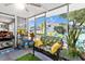 Bright sunroom featuring cozy seating, cheerful decor, and outdoor views at 8596 Sw 108Th Place Rd, Ocala, FL 34481