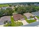 Aerial view of a single-story home in a manicured neighborhood with mature landscaping at 1424 Figueroa St, The Villages, FL 32162