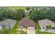 Aerial view of a single-story home in a manicured neighborhood with mature landscaping at 1424 Figueroa St, The Villages, FL 32162