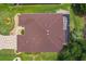 Birds eye view of the house showing the roof, screened-in patio, and backyard at 1424 Figueroa St, The Villages, FL 32162