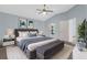 Bright bedroom with blue walls, a ceiling fan, plush carpet, and a comfortable king-sized bed at 1424 Figueroa St, The Villages, FL 32162