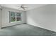 A bright, carpeted bedroom with a large window offering a pleasant view at 1424 Figueroa St, The Villages, FL 32162