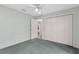Bedroom with green carpet, double closet, and light walls at 1424 Figueroa St, The Villages, FL 32162